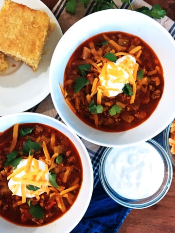 Quick and easy chili with a dollop of sour cream and shredded cheese.