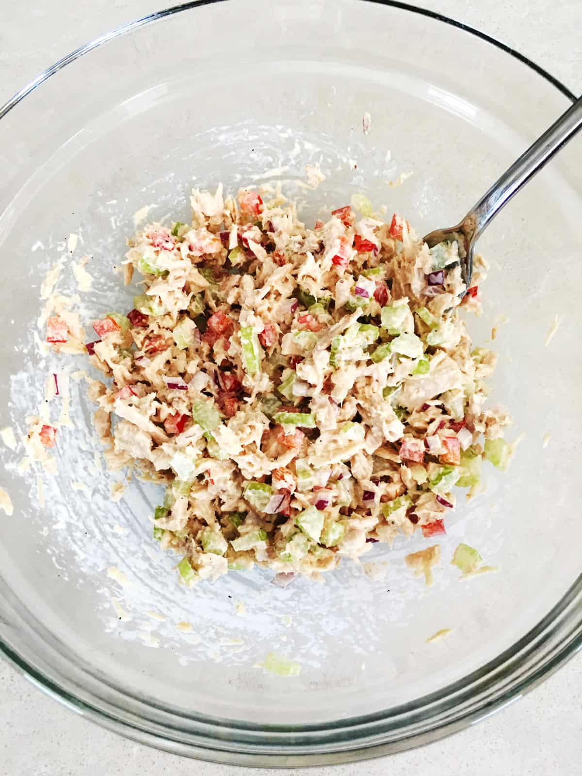 Freshly prepared tuna salad in a glass mixing bowl