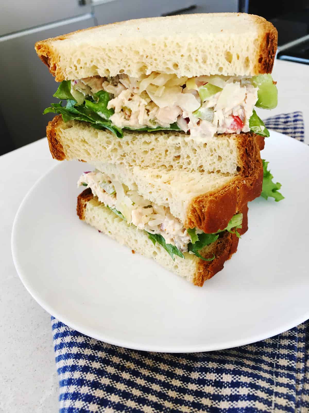 Close up of a tuna salad sandwich with sauerkraut and fresh lettuce.