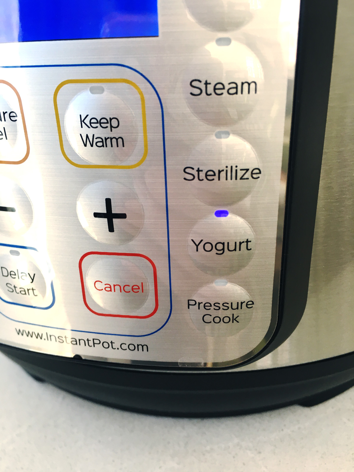 Instant Pot Yogurt button lit up in blue