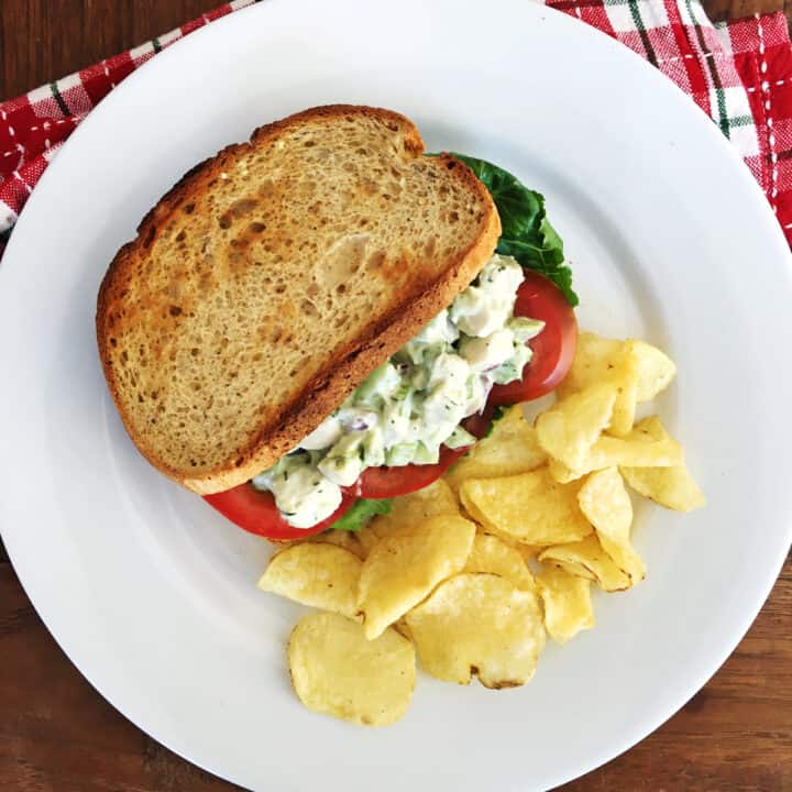 Chicken salad with avocado in a sandwich.