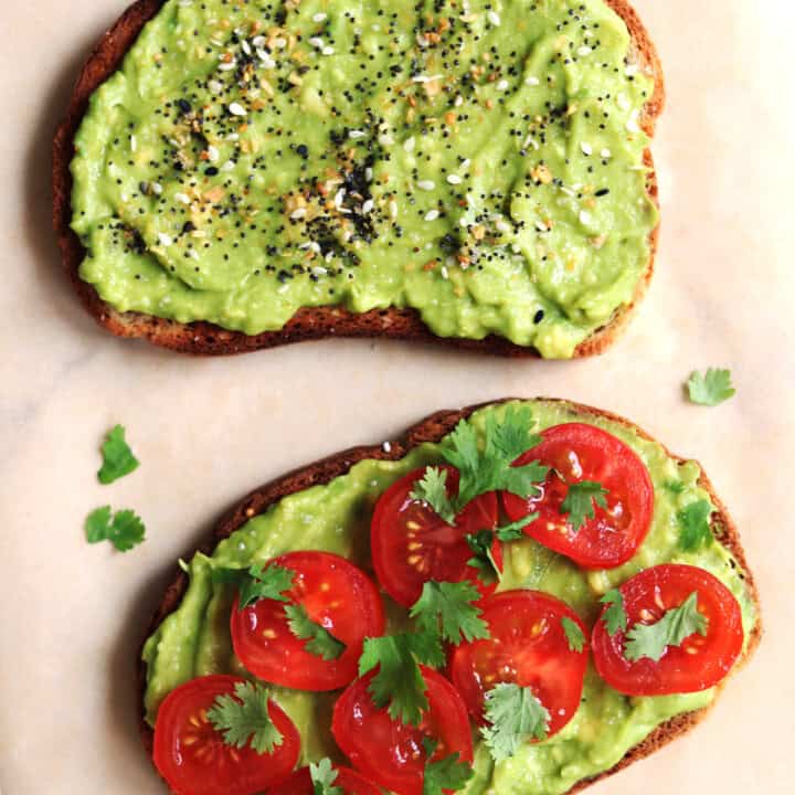 Two slices of avocado toast with different toppings.