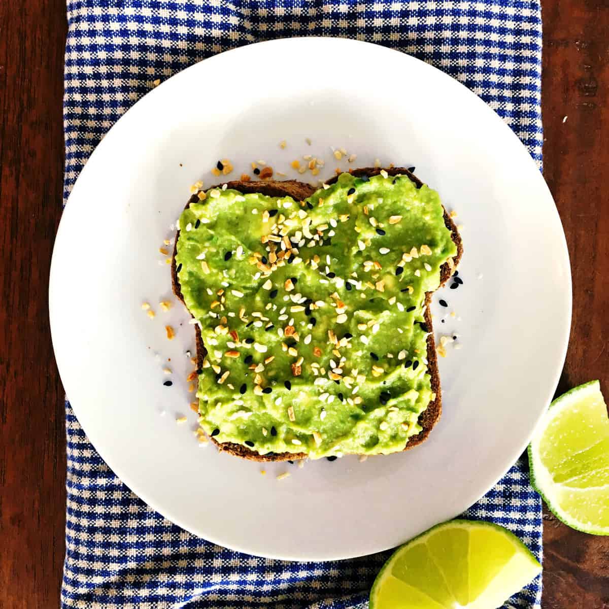 Avocado toast with everything bagel toppings on a white plate.