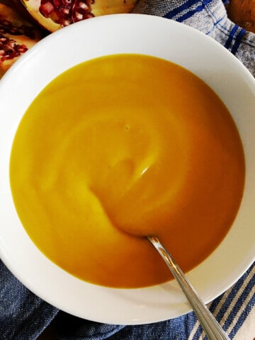 Roasted butternut squash soup in a white bowl