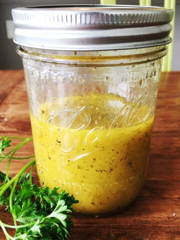 Apple cider vinaigrette dressing in a Mason jar.