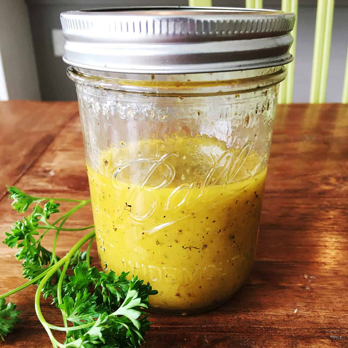 Apple cider vinaigrette dressing in a Mason jar.