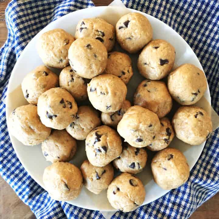 Peanut butter protein balls with chocolate chips on a white plate.