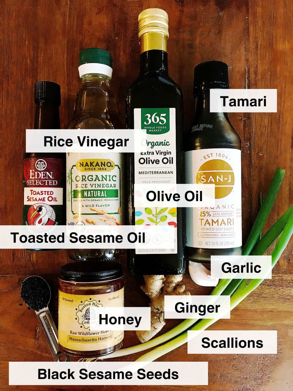 Asian salad dressing ingredients on a brown wood table.