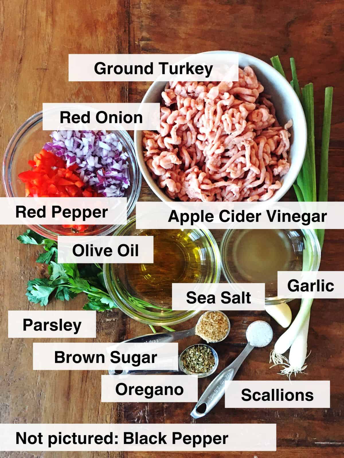 Turkey burger ingredients on a brown wood table.