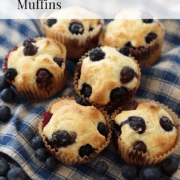 Homemade blueberry muffins on a blue and tan plaid napkin