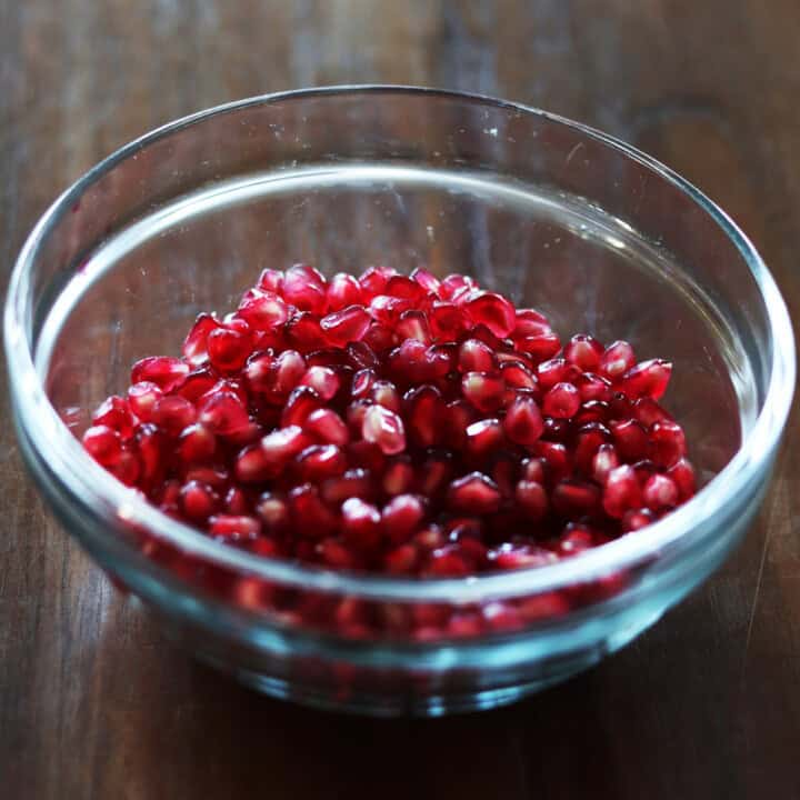 Pomegranate arils in a glass bowl.