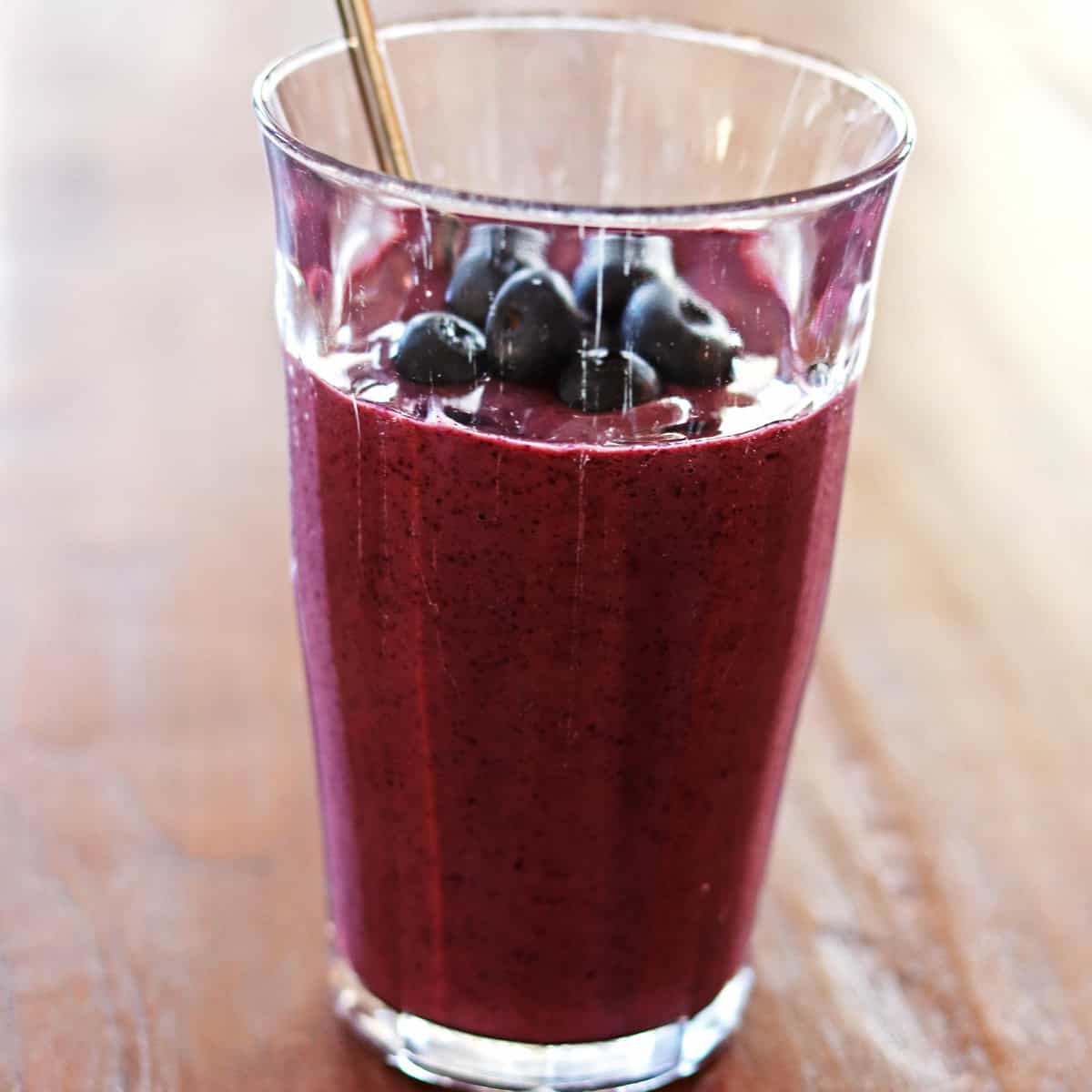 Blueberry kefir smoothie topped with fresh blueberries.