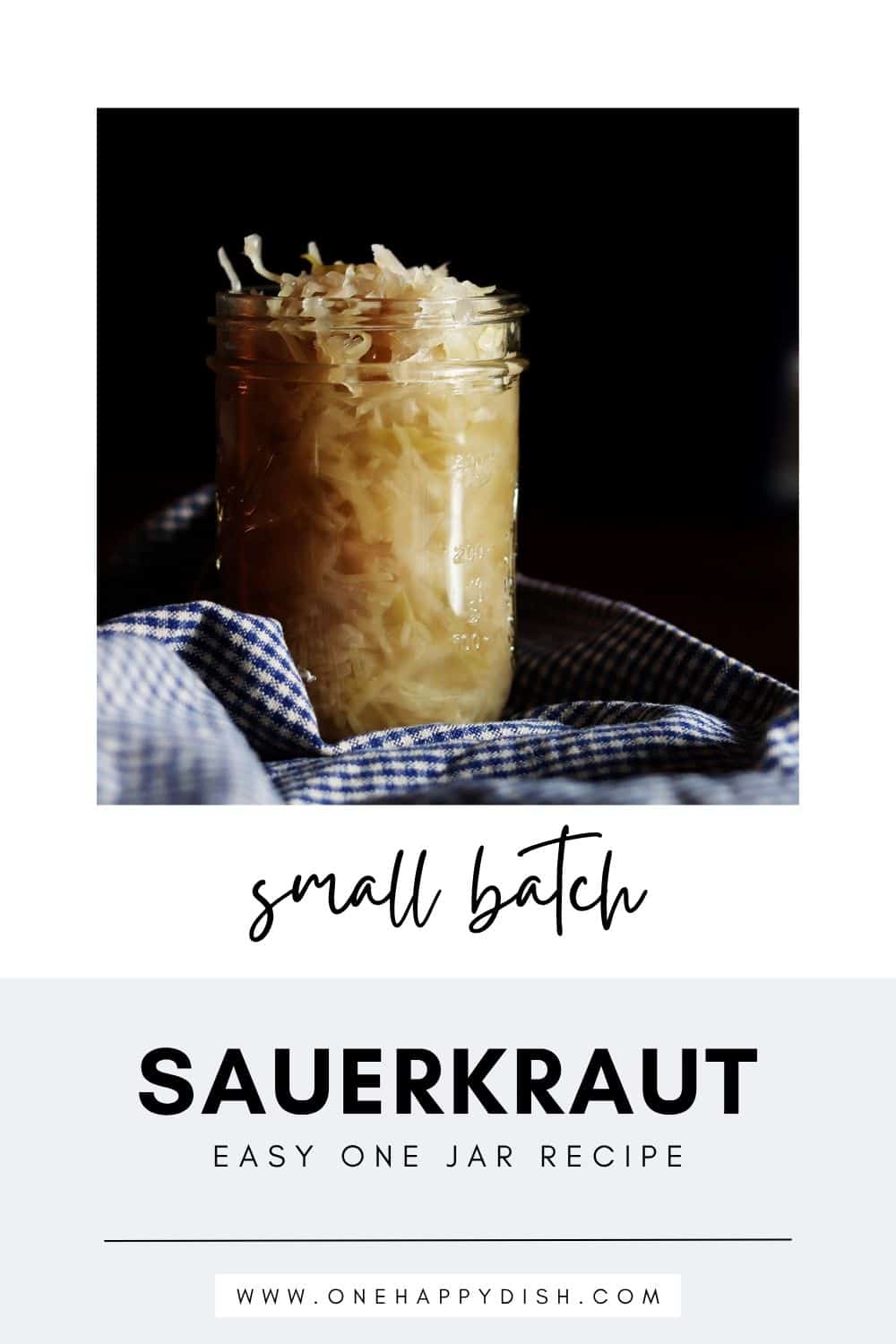 Homemade sauerkraut in a glass Mason jar with a blue and tan checkered napkin.