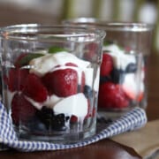 Yogurt parfaits with fresh berries in glass working jars.