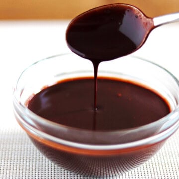 Chocolate sauce drizzled into in a glass bowl.