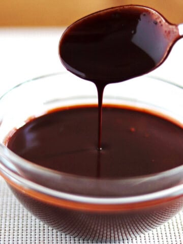 Chocolate sauce drizzled into in a glass bowl.