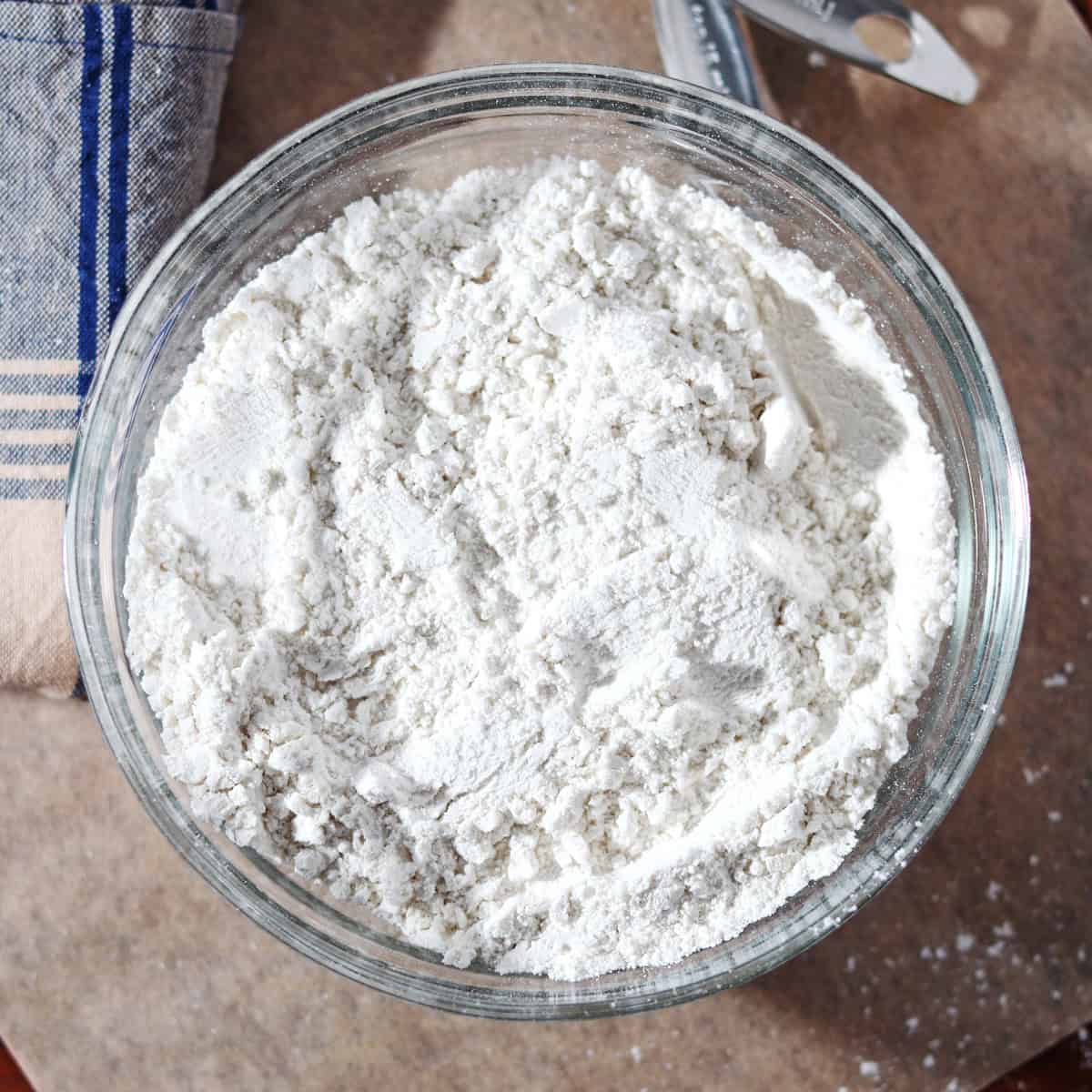 Homemade self rising flour in a glass bowl.