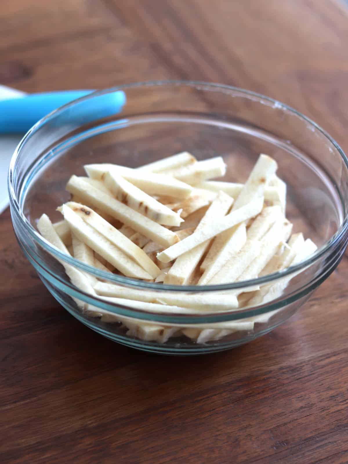 Jicama sticks in a glass bowl.