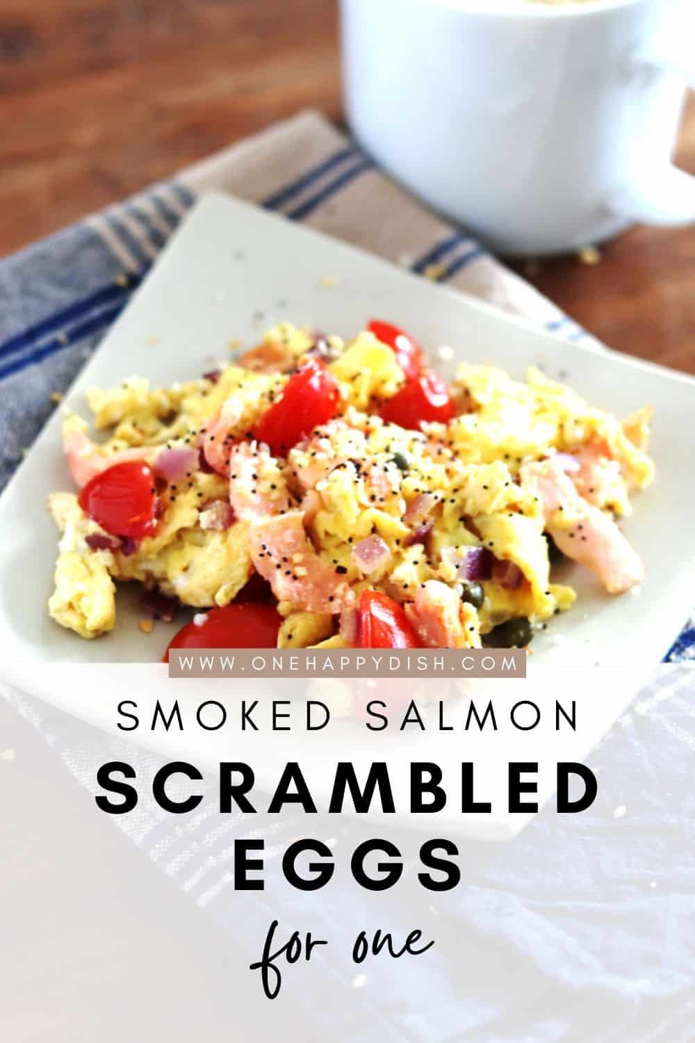 Scrambled eggs with smoked salmon on a square ceramic tan plate.