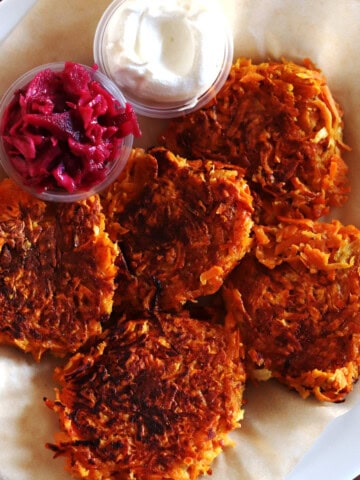 Sweet potato latkes with sides of beet kraut and sour cream.