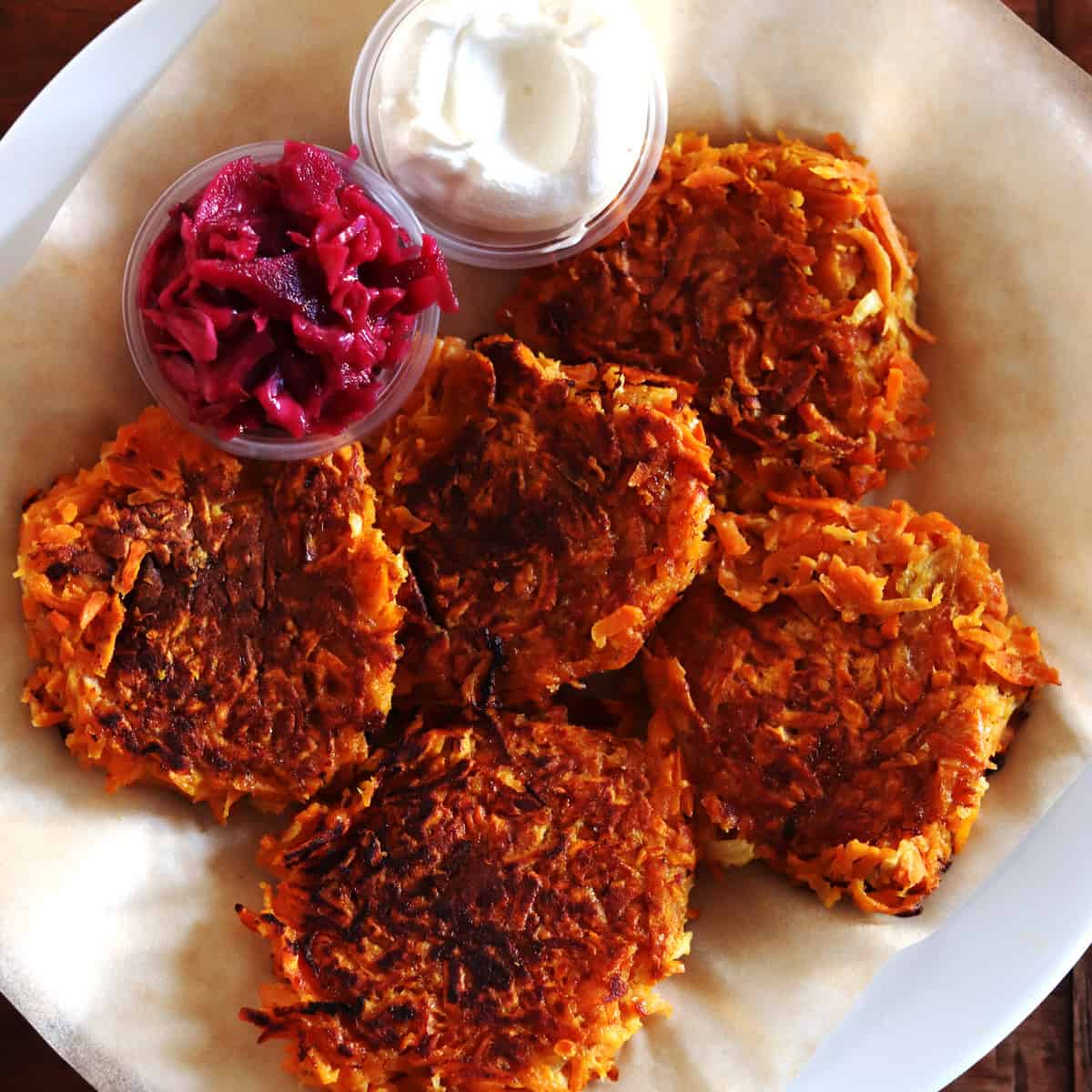 Sweet potato latkes with sides of beet kraut and sour cream.