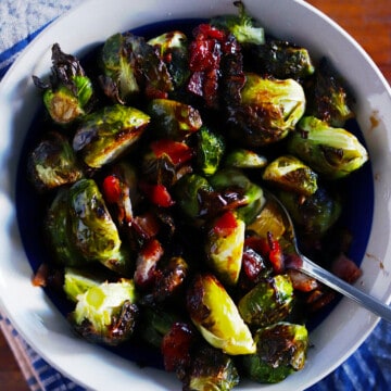 Roasted Brussels sprouts and bacon in a ceramic bowl.