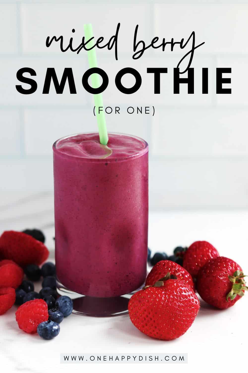 A mixed berry smoothie alongside fresh mixed berries.
