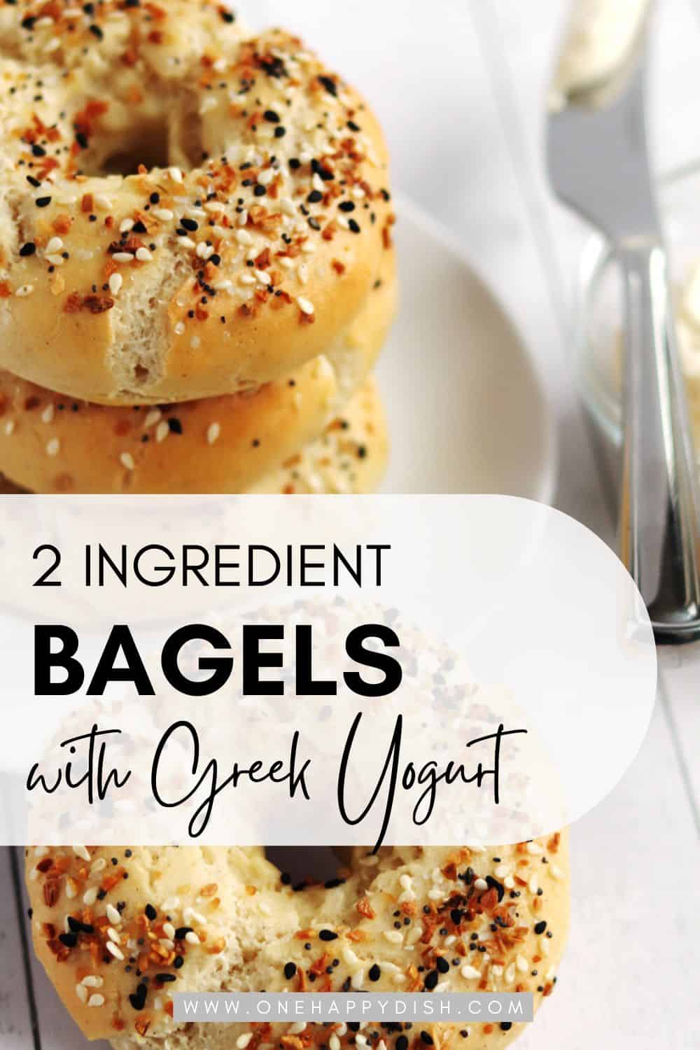 A closeup of homemade bagels on a rustic white wood table.