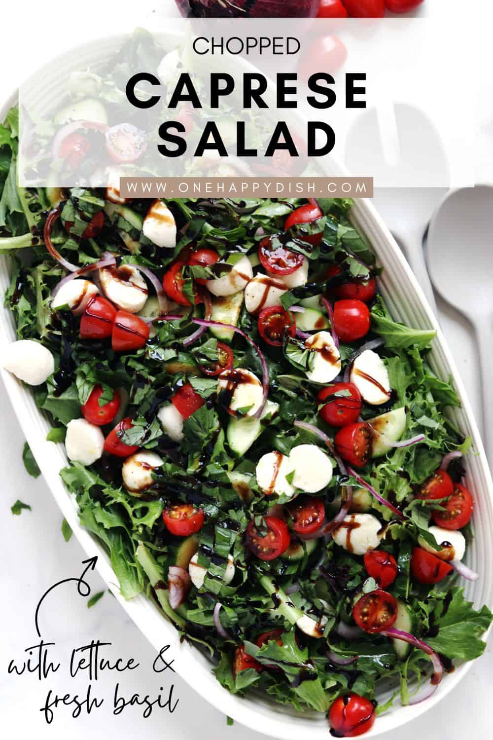 Chopped Caprese salad on a beige ceramic serving platter.