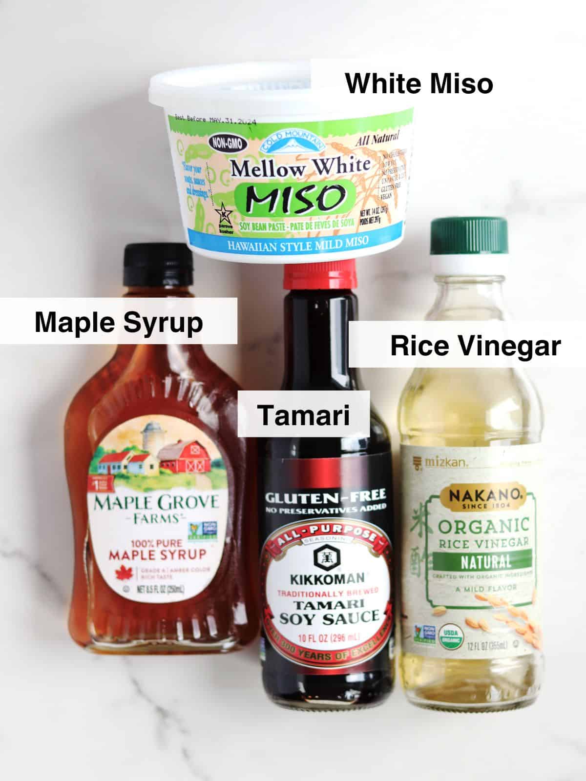 Ingredients for miso sauce displayed on a white marble countertop.