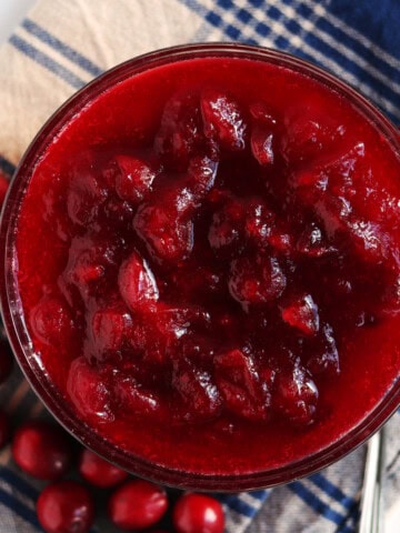 Homemade cranberry sauce in a glass serving dish.