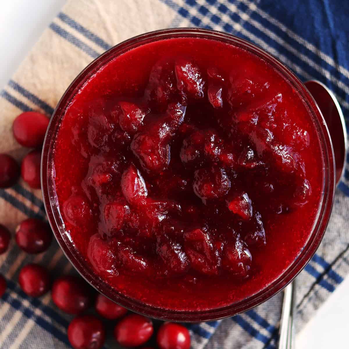 Homemade cranberry sauce in a glass serving dish.