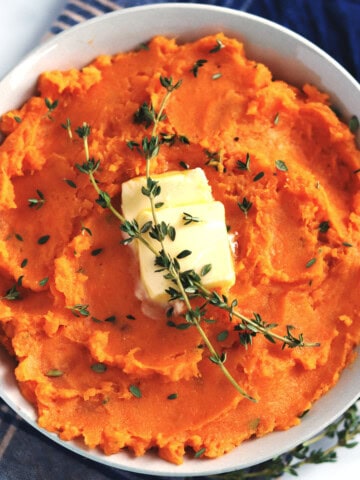 Miso mashed sweet potatoes garnished with fresh thyme.