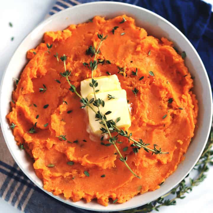 Miso mashed sweet potatoes garnished with fresh thyme.