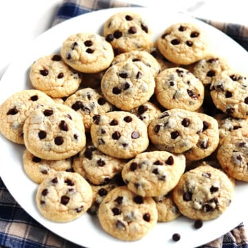 Mini chocolate chip cookies on a white plate.