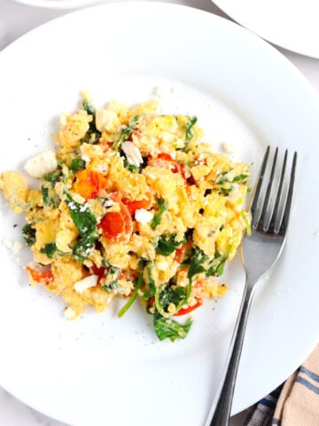 Greek scrambled eggs on a white plate.