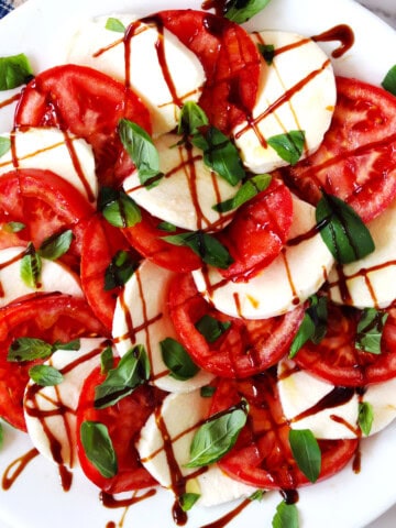 Caprese salad on a white serving plate.