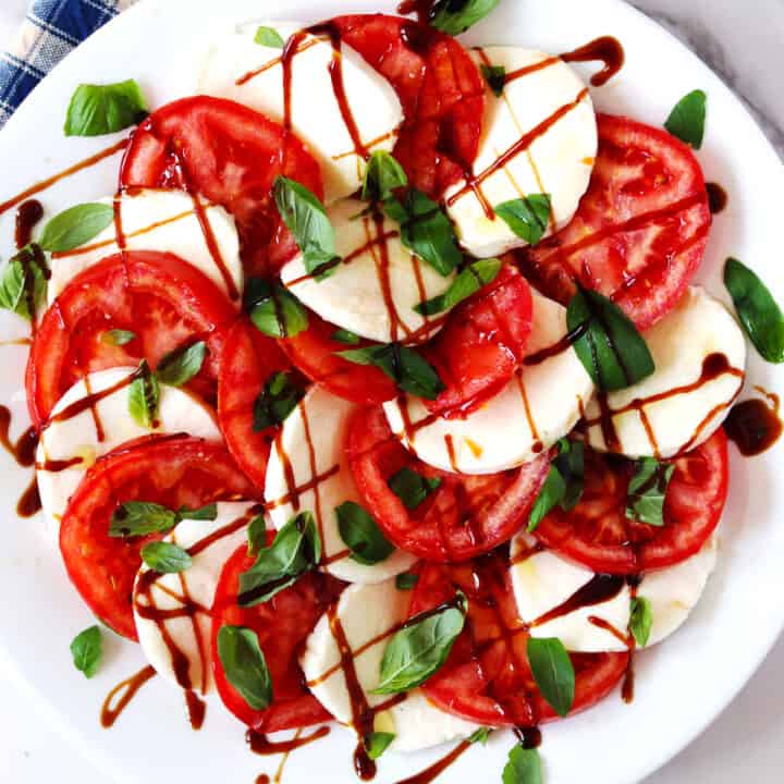 Caprese salad on a white serving plate.