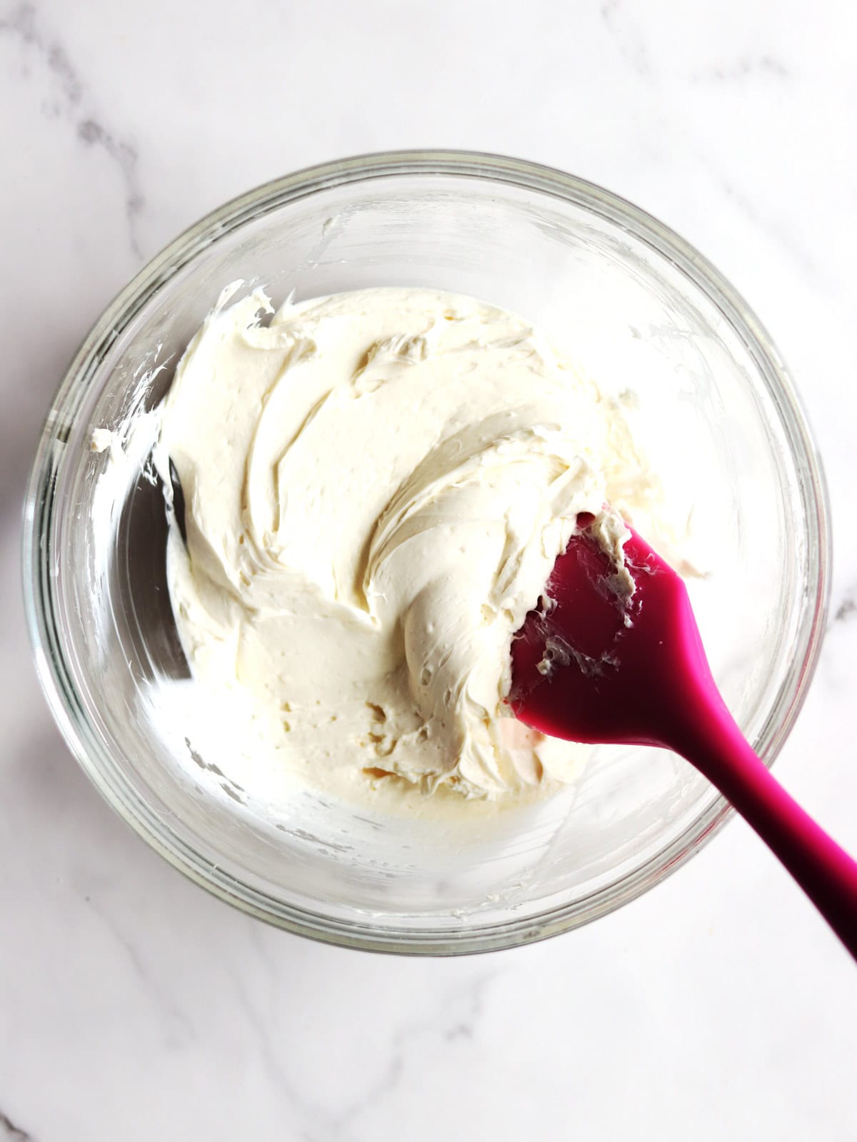 Sweet cream cheese filling in a glass bowl.