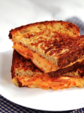 Kimchi grilled cheese sandwich on a white plate.