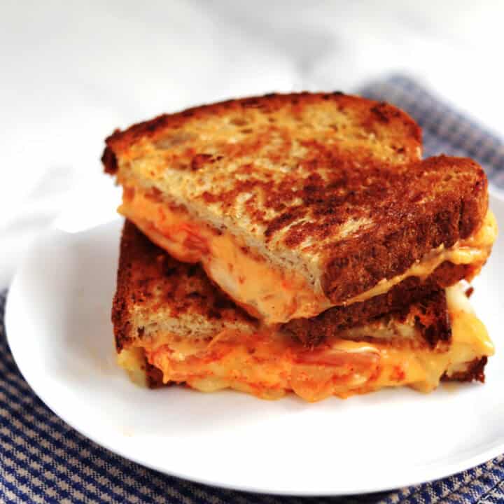 Kimchi grilled cheese sandwich on a white plate.