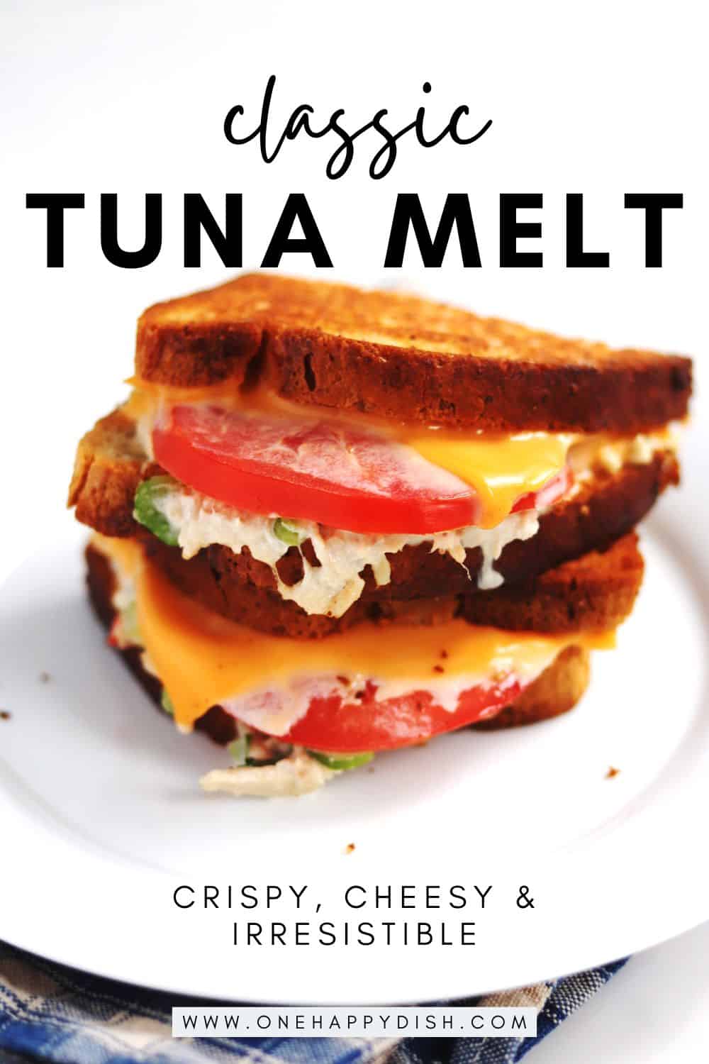 A classic tuna melt sandwich with layers of tuna salad, American cheese, tomato, and tuna salad between two slices of toasted bread, served on a white plate. Text reads: Classic Tuna Melt - crispy, cheesy & irresistible.