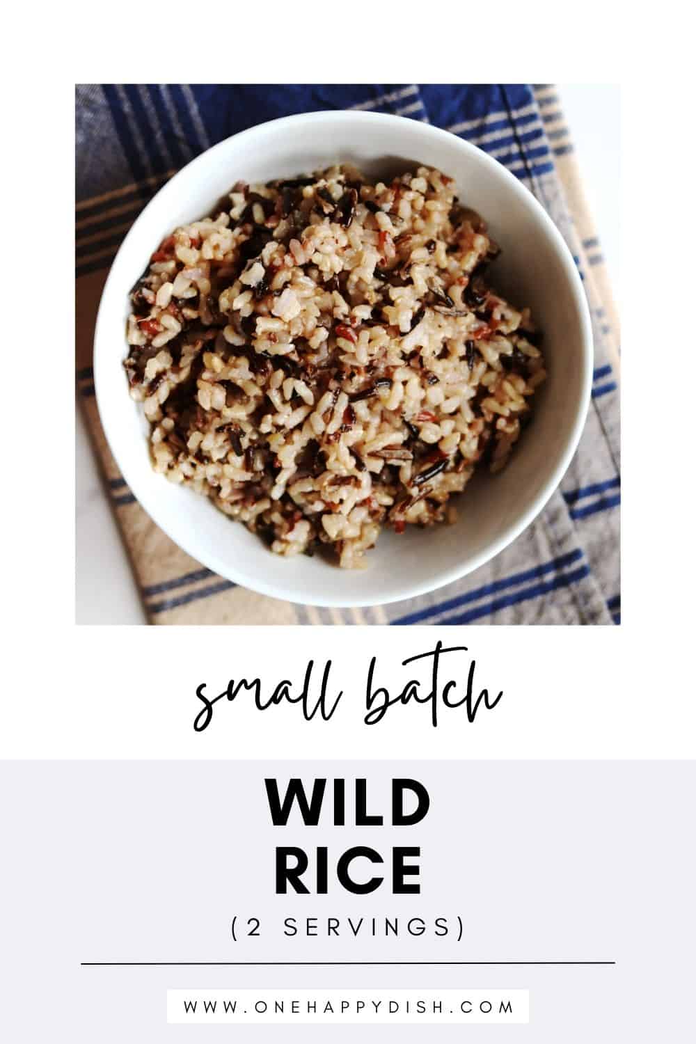 A bowl of cooked wild rice sits on a blue and beige plaid napkin. Text below reads: Small batch wild rice (2 servings) and www.onehappydish.com.