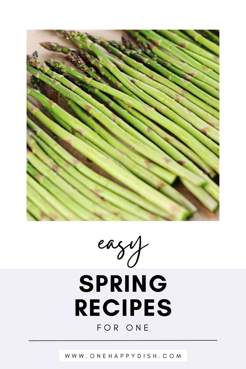A close-up of fresh, uncooked asparagus spears laid out on parchment paper, featured above the text Easy Spring Recipes for One and a website link to www.onehappydish.com.